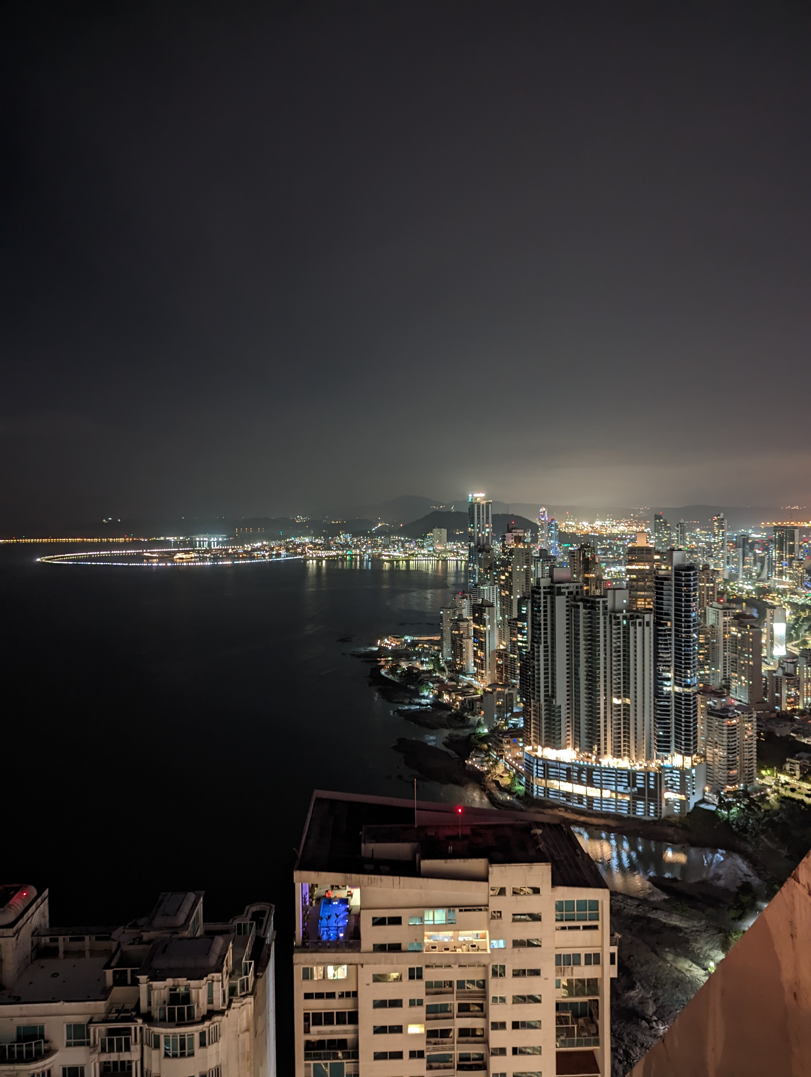 Illuminated high-rise buildings punctuate the night skyline.