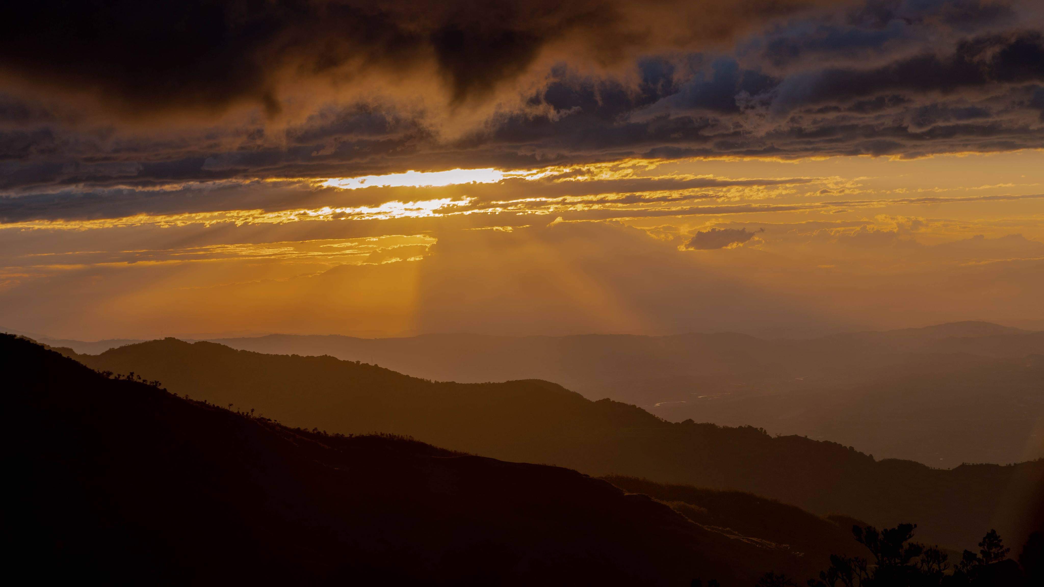 Warm amber light falls over distant mountain ridges.
