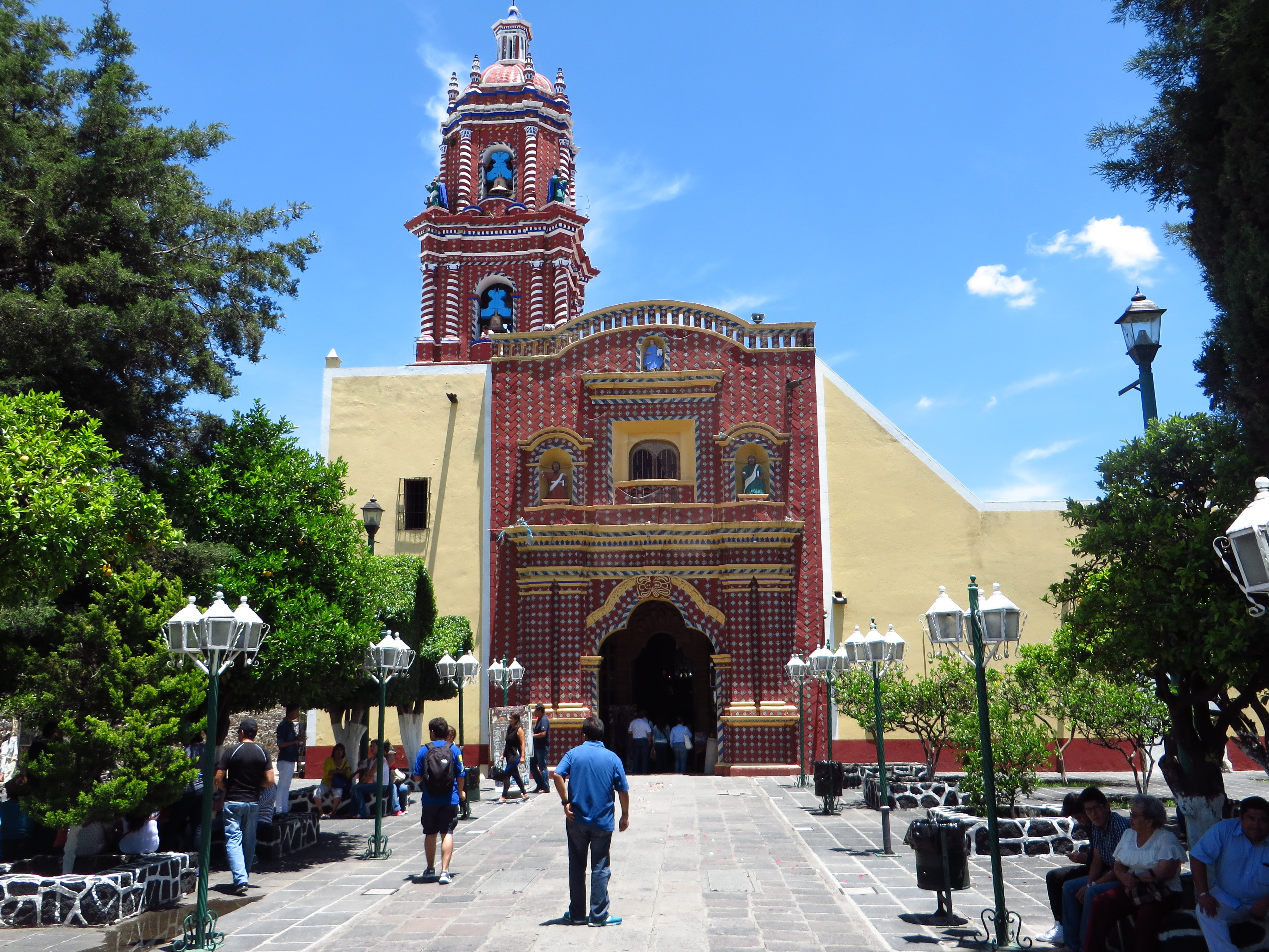 An ornate red church façade with decorative architectural details.